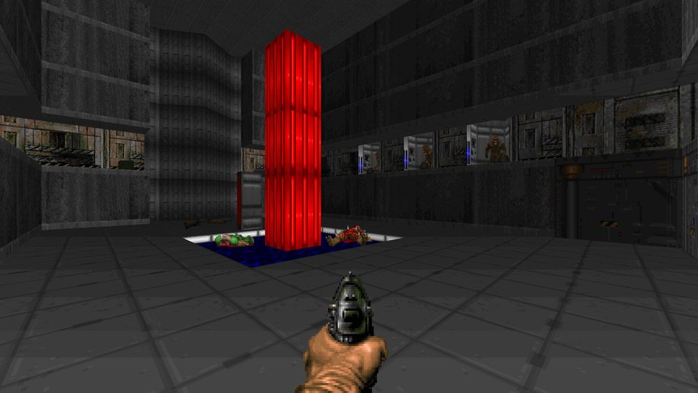 Doom screenshot showing a large concrete room with a pool of water in the middle and a glowing red pillar emerging from it. Alcoves filled with imps line an upper walkway.