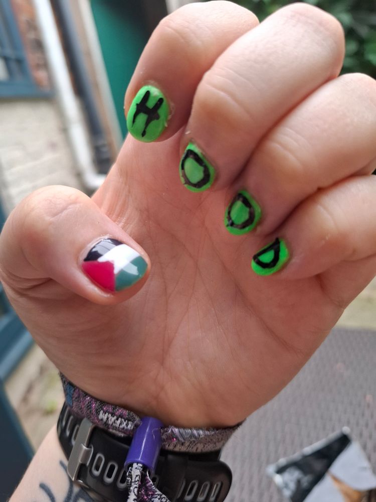 Hand with Palestinian flag nail art on thumb, green on other nails and "H.O.OD" on each fingernail