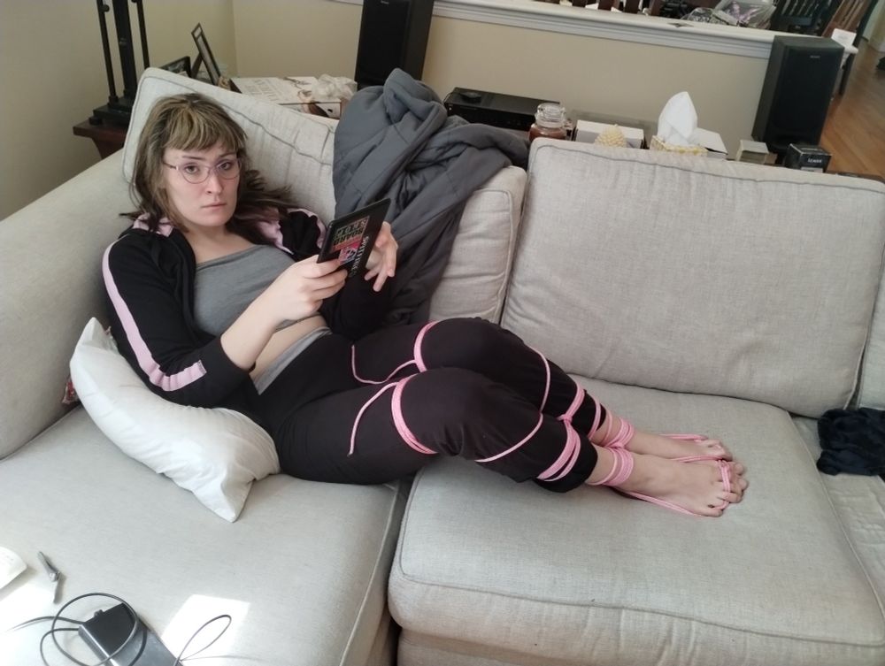 Lily with legs tied up watching a movie!