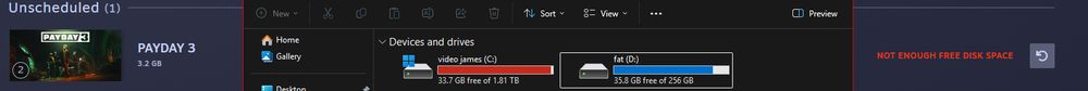 in the background you can see the steam's app page for downloads, namely showing the "unscheduled" section with one entry, payday 3 for a 3.2 GB update. It's saying there's not enough free disk space for the update on the right
In the foreground, a file explorer window is open, showing both my connected drives, "video james", my C: drive, has 33.7 GB free out of 1.81 TB, and "fat", my D: drive, has 35.8 GB free out of 256 GB. 
