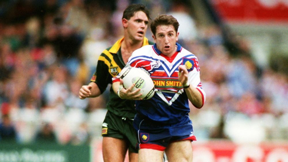 Jonathan Davies in a Great Britain strip holding the ball and racing away from a forlorn looking Australian as he romps home to score a try when we beat Australia with only 12 men in 1994