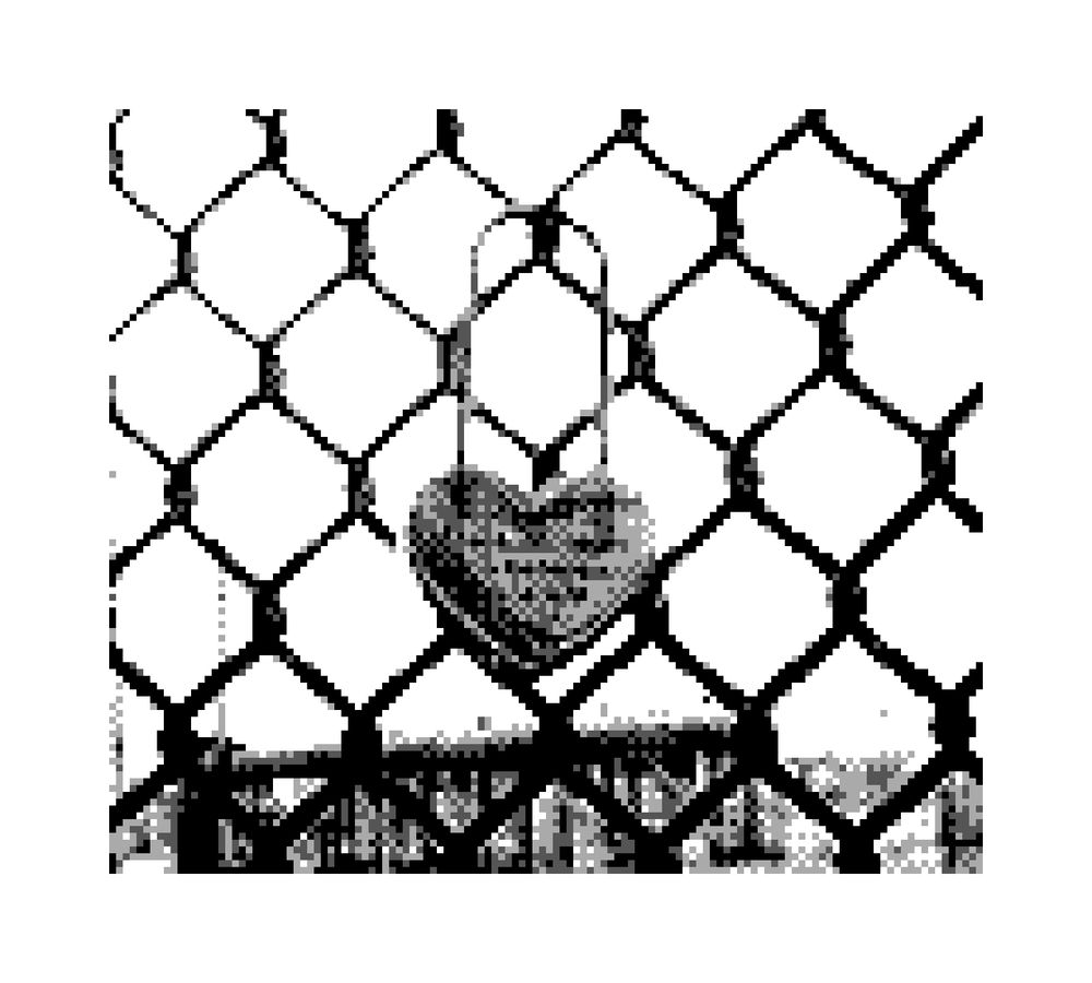 Game Boy Camera of a heart shaped lock with text attached to a chain link fence.