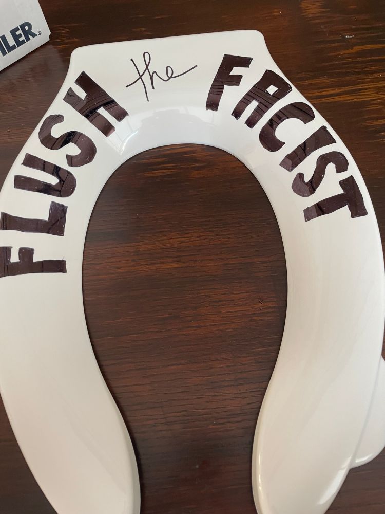 Toilet seat with ‘Flush the Fascist’ written on it