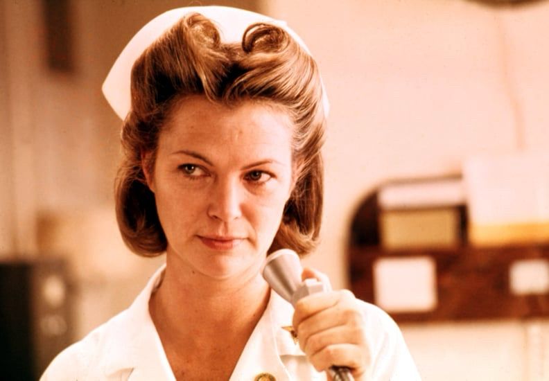 A nurse in uniform preparing to speak into a microphone.