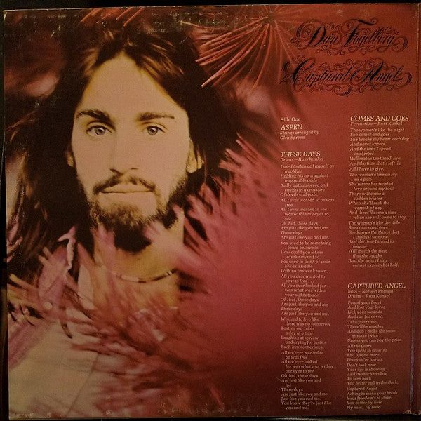 Close up of a bearded, long- haired young man, framed by pine branches. To the right are lyrics from several songs: Dan Fogelberg: Captured Angel