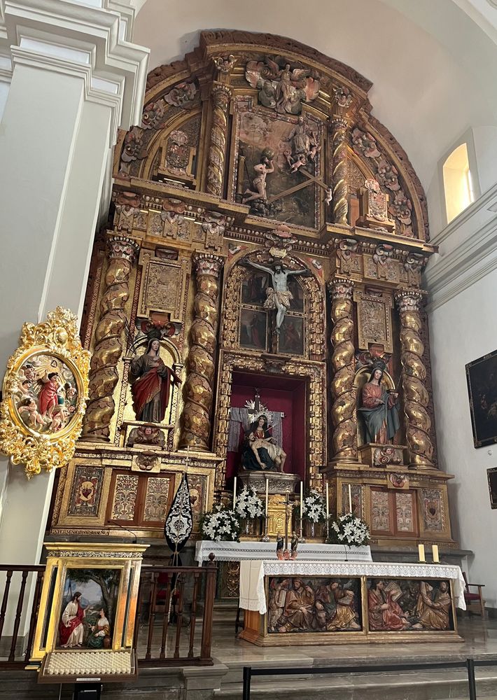 An intricate alter screen with statues and a crucifix