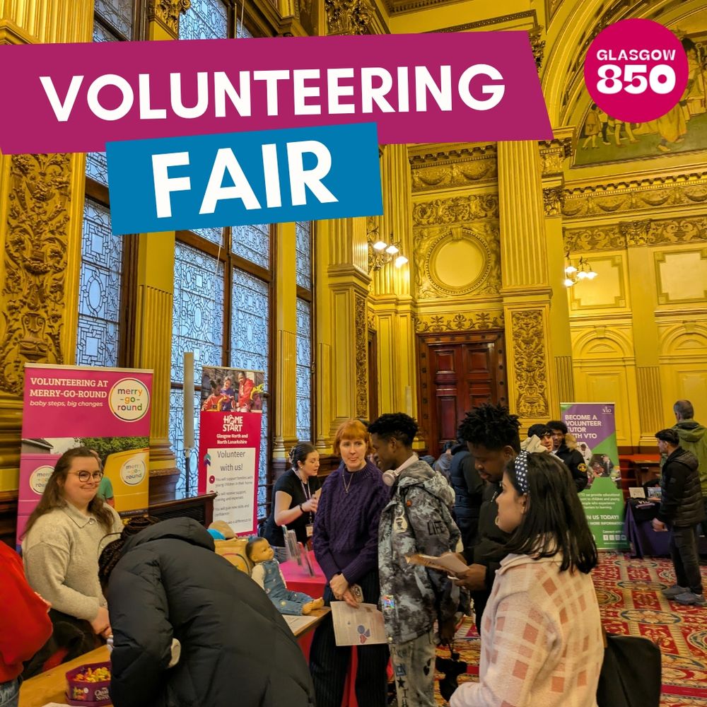 1. A photograph of a beautiful large hall in Glasgow City Chambers. There are stalls with banners for charity organisations, Merry Go Round and Home Start Glasgow North. There is a group of people looking at the stalls and talking. Text reads "Volunteering Fair".
