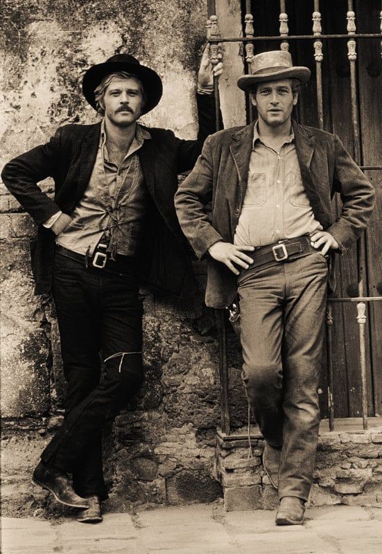 A b/w production still from 'Butch Cassidy and the Sundance Kid' with Robert Redford & Paul Newman dressed as their characters.