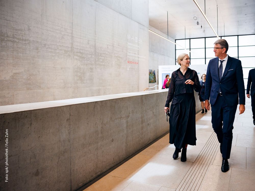 Marion Ackermann und Wolfram Weimer lauf einen Gang im Neuen Museum entlang und unterhalten sich.