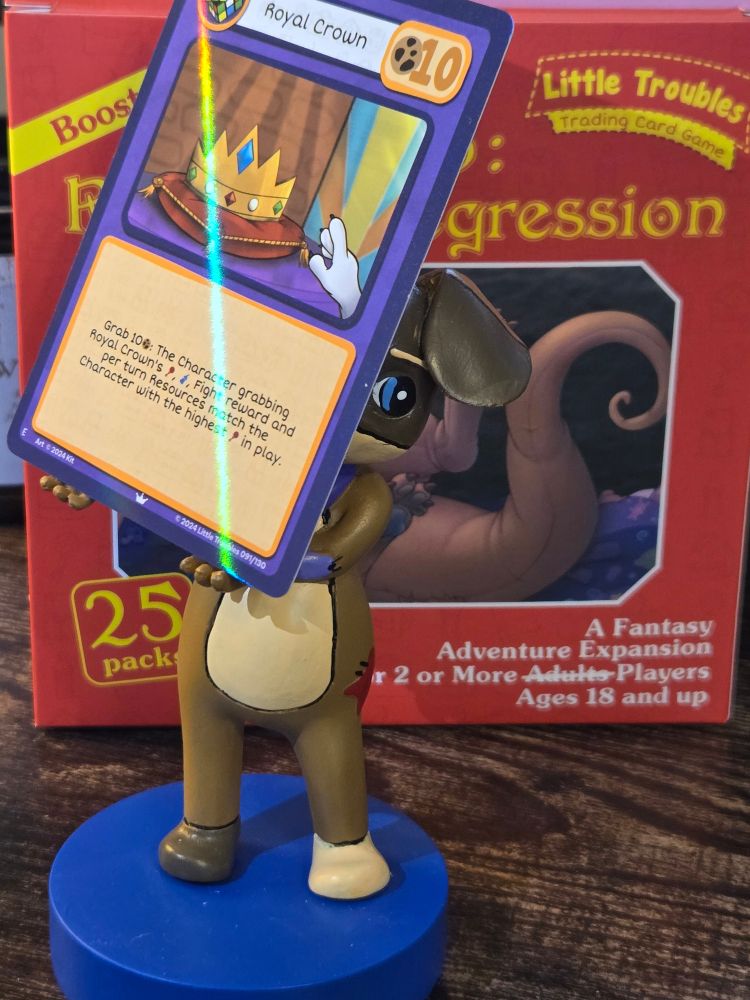 A Patches statue holding up a 'Royal Crown' card