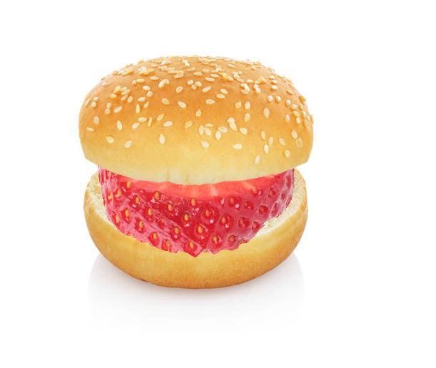A PNG of a strawberry slice between two buns. These are two photos edited together. 