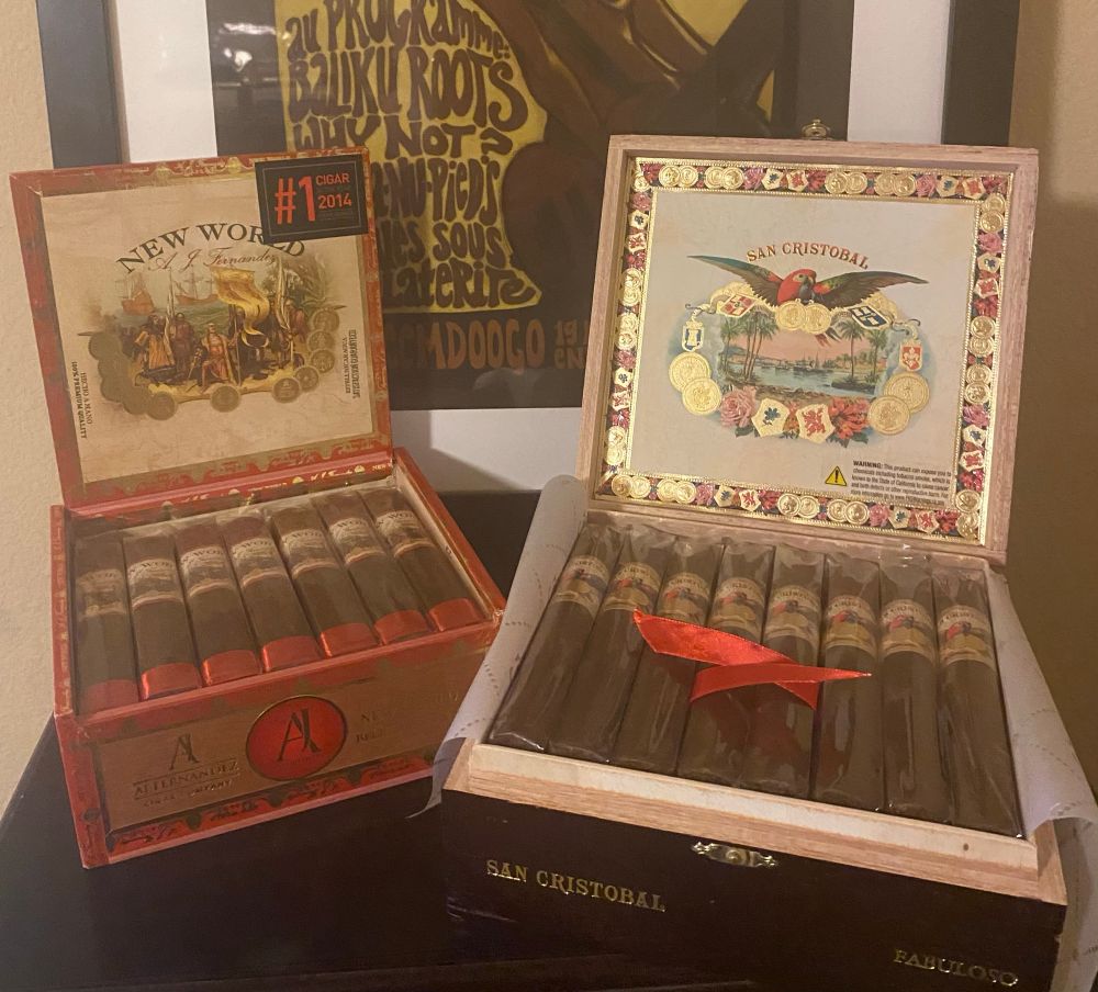 Two open boxes of cigars—-A.J. Fernandez New World belicosos and San Cristobal fabulosos.