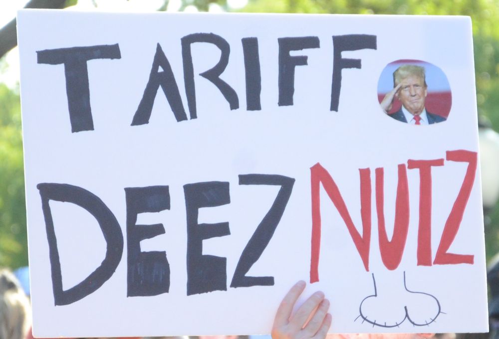 A protest sign at the Austin No Kings rally which reads "Tariff Deez Nutz"