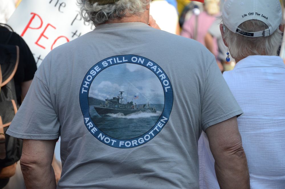 A veteran at the Austin No Kings rally, wearing a shirt which reads "Those Still On Patrol Are Not Forgotten"