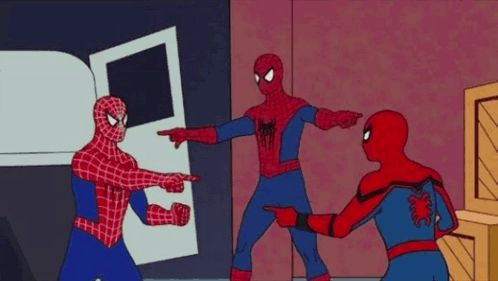 three men in spiderman costumes are standing next to each other in a circle and pointing at each other .