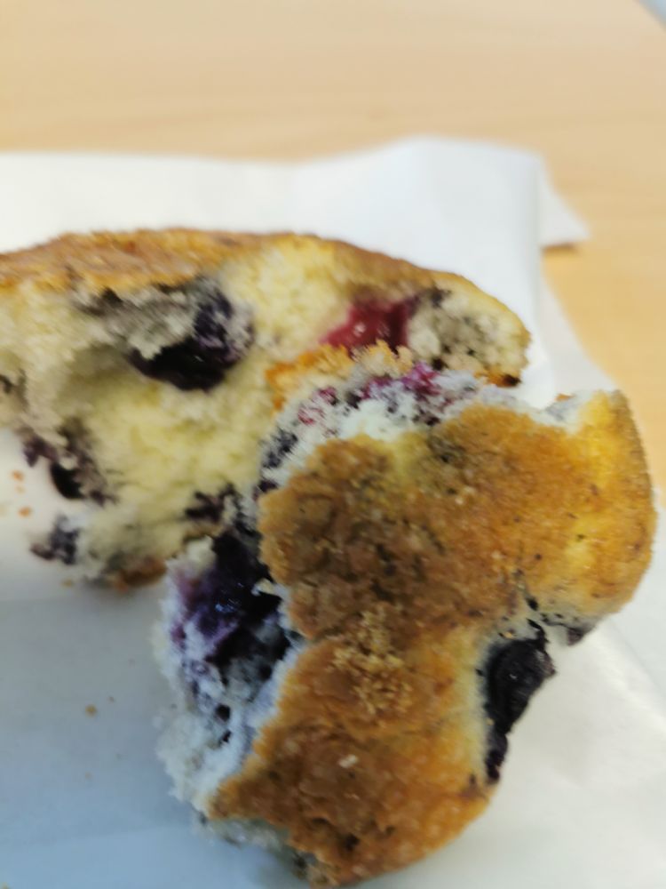 Out of focus image of blueberry muffin, torn in half 