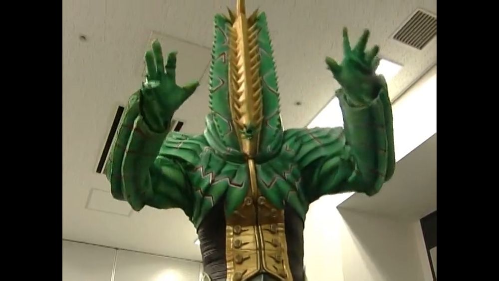 The Youma from episode 4 of Pretty Guardian Sailor Moon

A mostly green monster with a head consisting of two sawblade like parts forming a V, with a series of yellow spines protruding down the middle. This isn't a great description, but this is a weird fucking thing