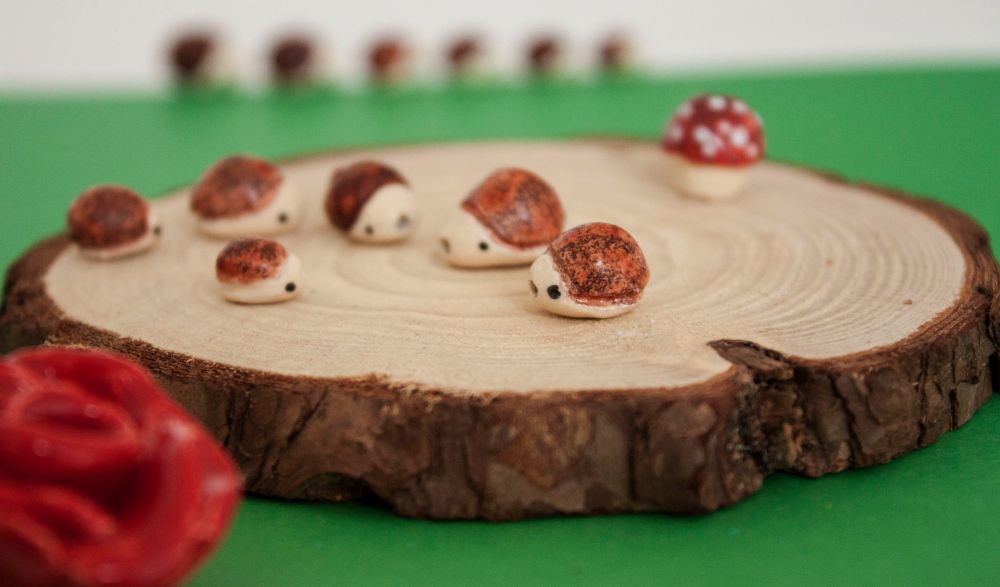 Group of hedgehog beads assembled on a piece of wood