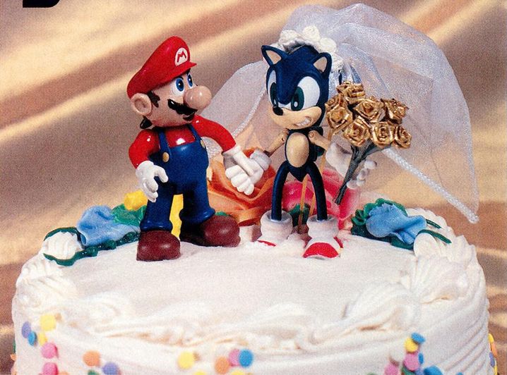 mario and sonic on top of a wedding cake (sonic is the bride and is holding flowers). they are holding hands.