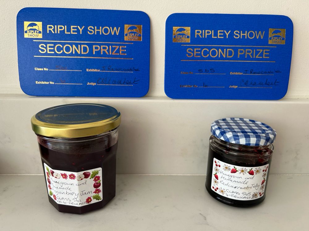 Jar of loganberry jam and jar of redcurrant jelly, with two cards saying Ripley Show, second prize