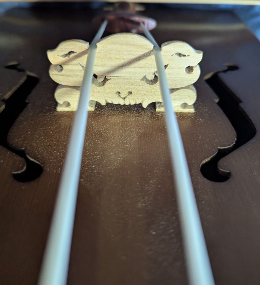 Bridge of a horsehead fiddle carved to resemble a demon's face