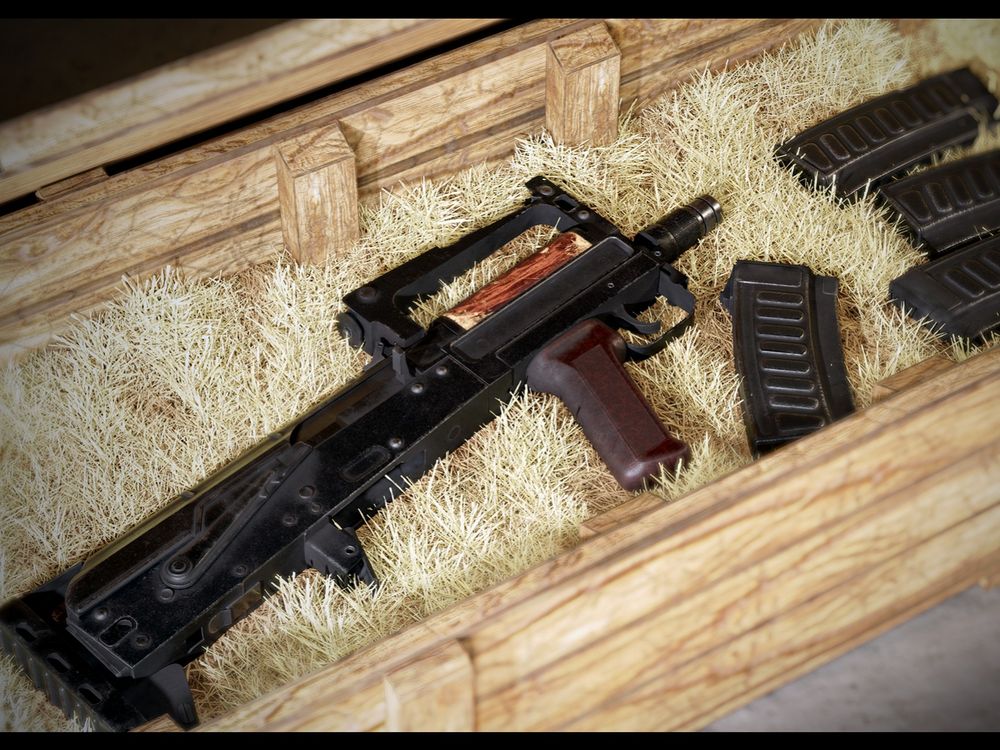 A groza placed in a crate of thatch aside its magazines.