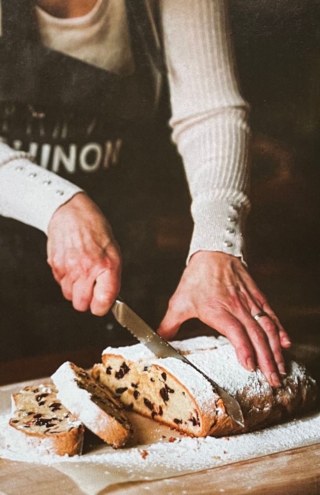 Magazine photo of me slicing traditional Christmas stollen.