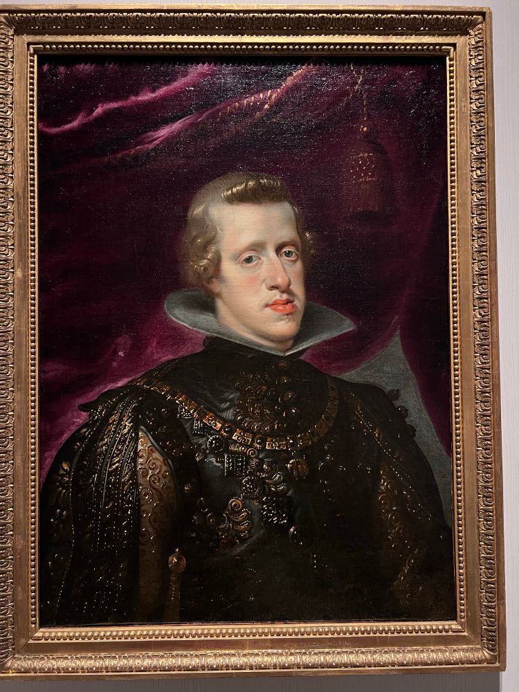 Painting of a young man in dark-and-golden clothes with the most impressively elongated jaw, the typical sign of Habsburgs preferring to marry ‘in the family’, in those days. 