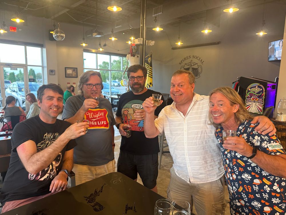 Five men with shots of Malort, a horrible whiskey.
