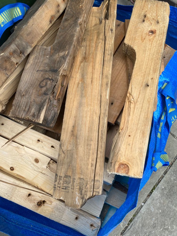 A blue ikea bag full of sawn wooden boards 
