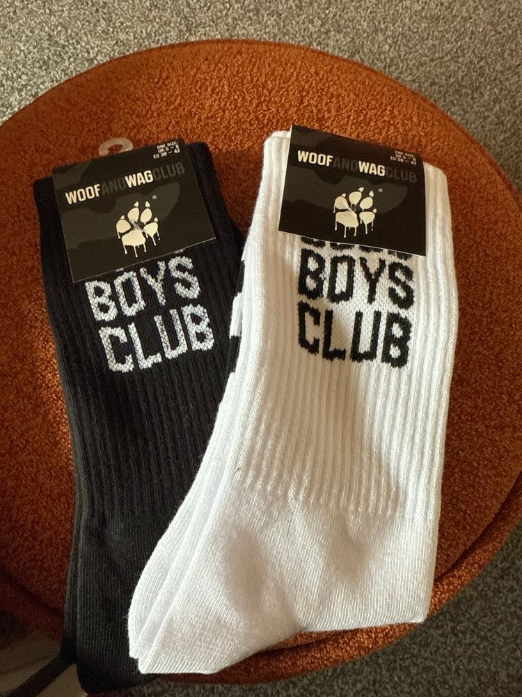 A pair of black and a pair of white socks saying “good boys club”