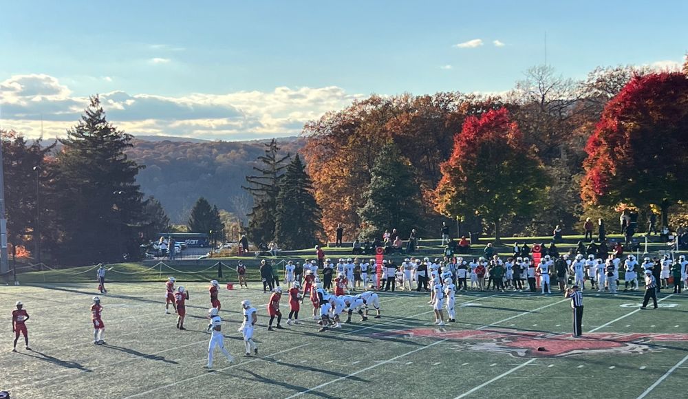 Sunny football field with players 