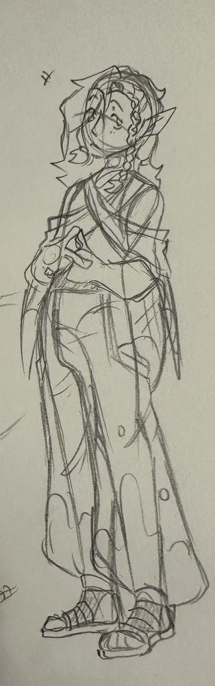 Younger Hen Ry’Oak design. He’s a small man with hair down to his shoulders, pointed ears, and a boho-like style, including baggy pants, folded cloth over his shoulders, and Birkenstocks. Always Birkenstocks.