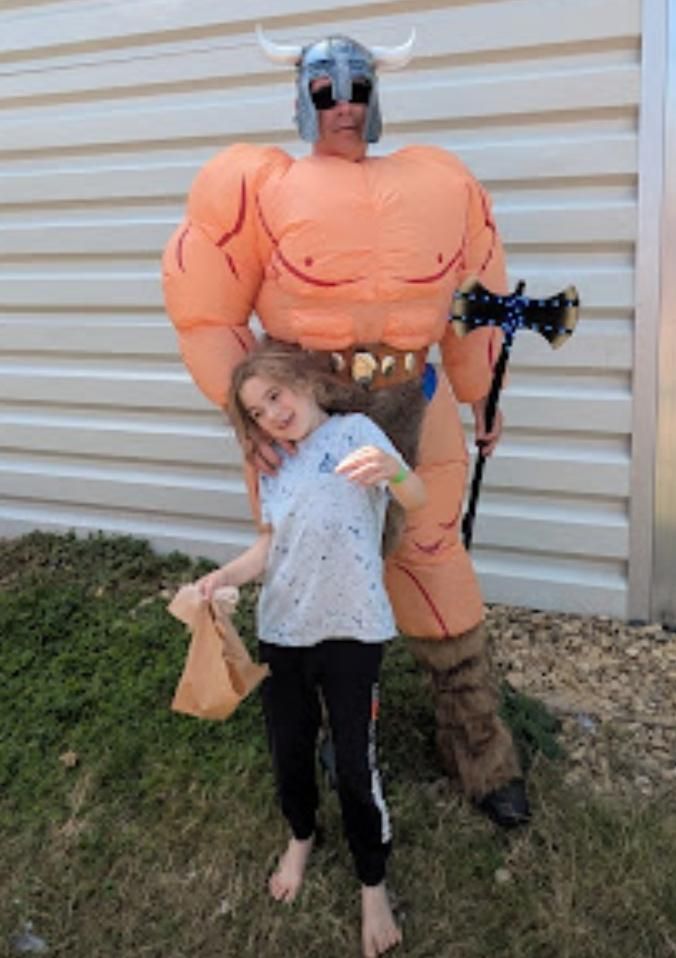Eldritchfox dressed up as thrud the barbarian with Solar Punk sunglasses and someone else's kid