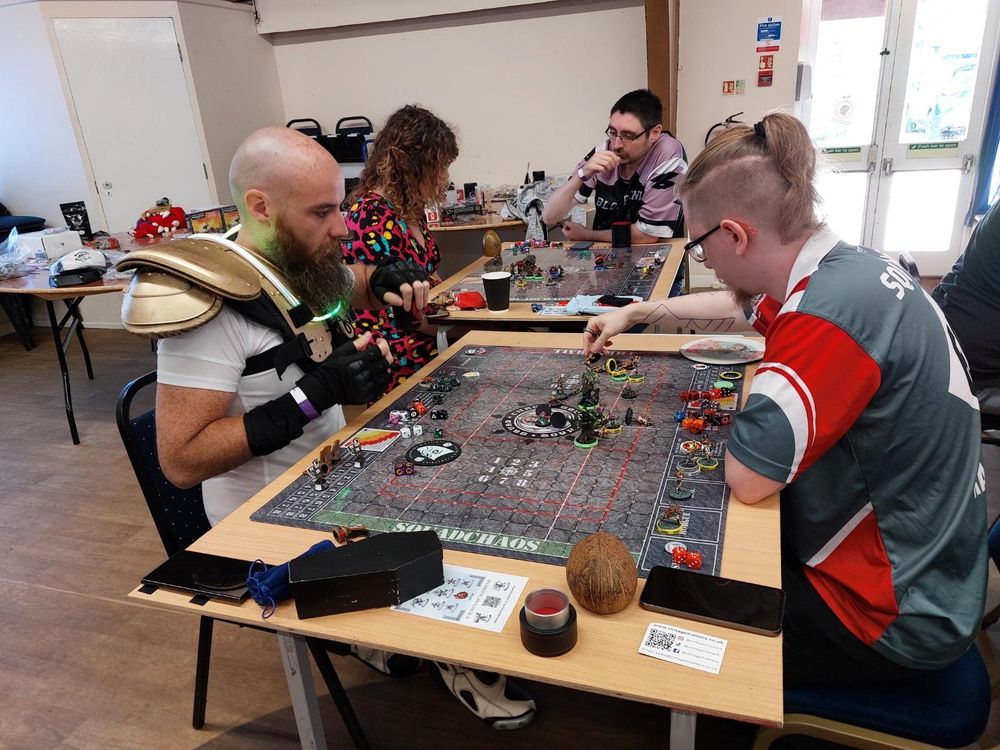 Torquemada with his futuristic body armour and Hargrim, with no body armour, playing a game
