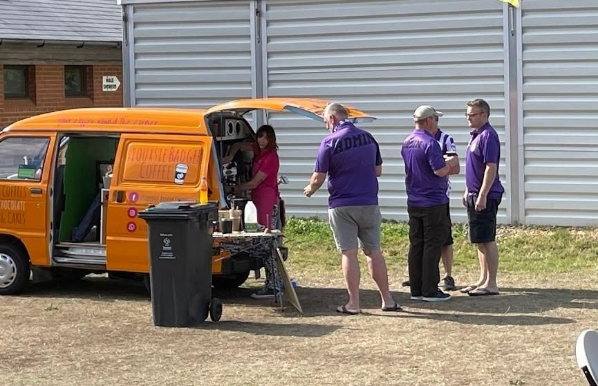 A queue of admins grabbing a good coffee from a bright orange van with badger paw prints. Sarah/Siouxsie did a great job and a lot of the positive feedback involved her