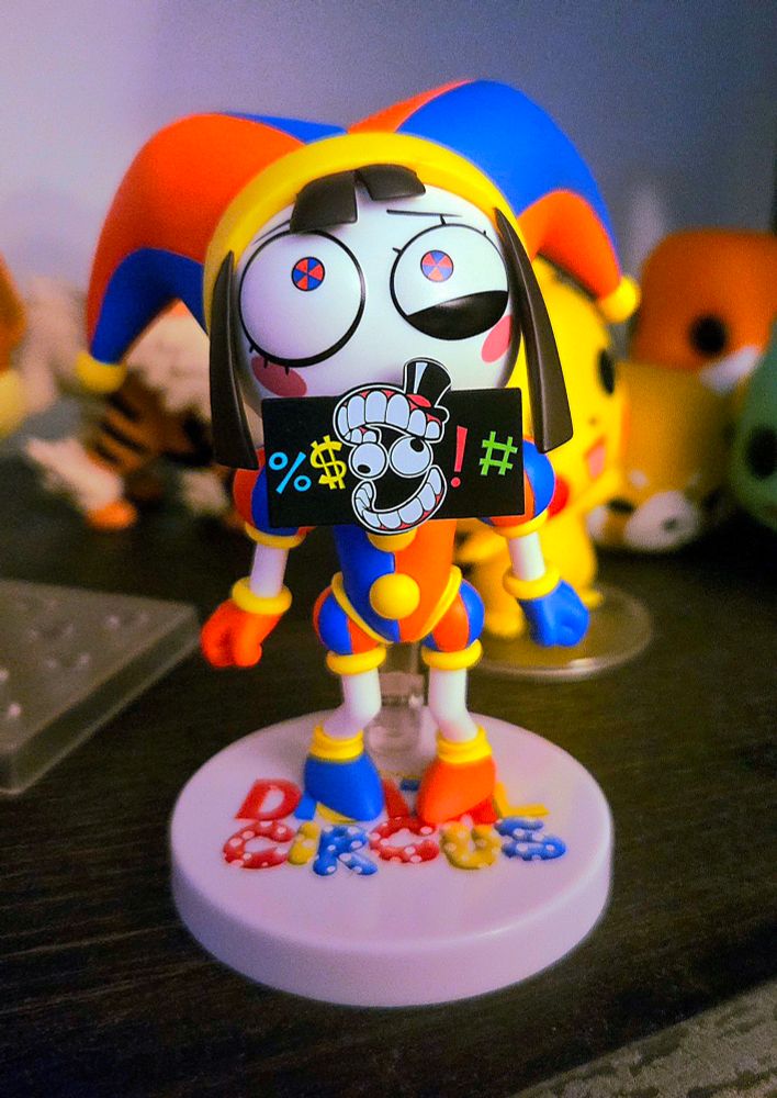 A nendoroid figure of Pomni. She has the cursing censor add on over her mouth.