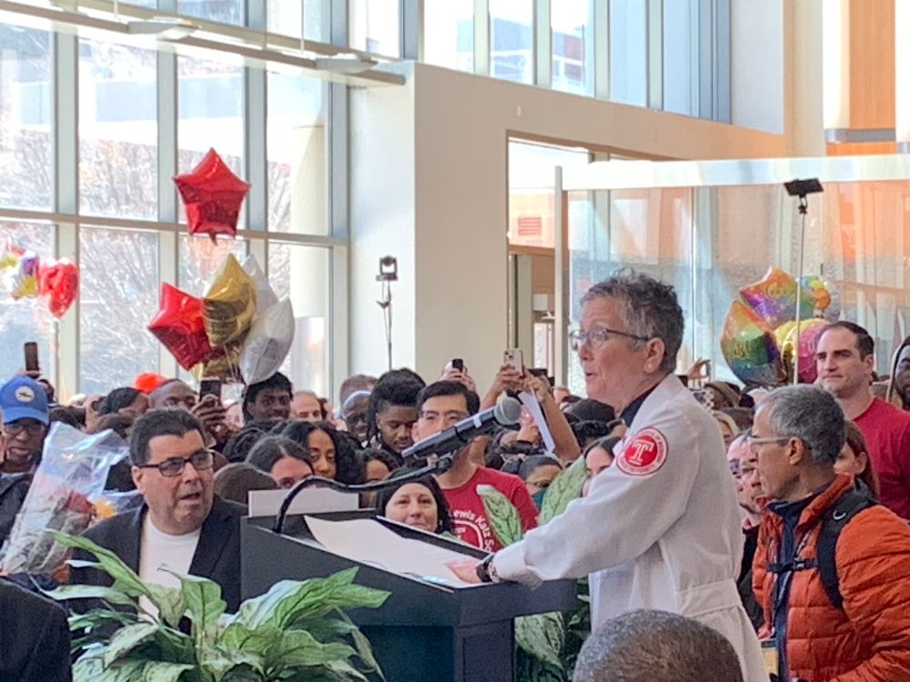 Dean Amy Goldberg counting down to opening of envelopes at Lewis Katz School of Medicine surrounded by students and supporters