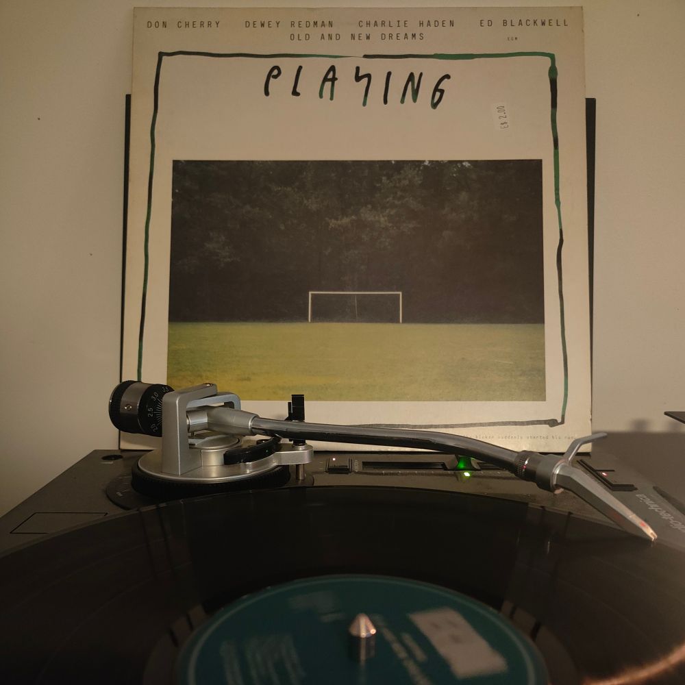 LP sleeve of Old And New Dreams - Playing propped up behind a turntable which is playing the album.