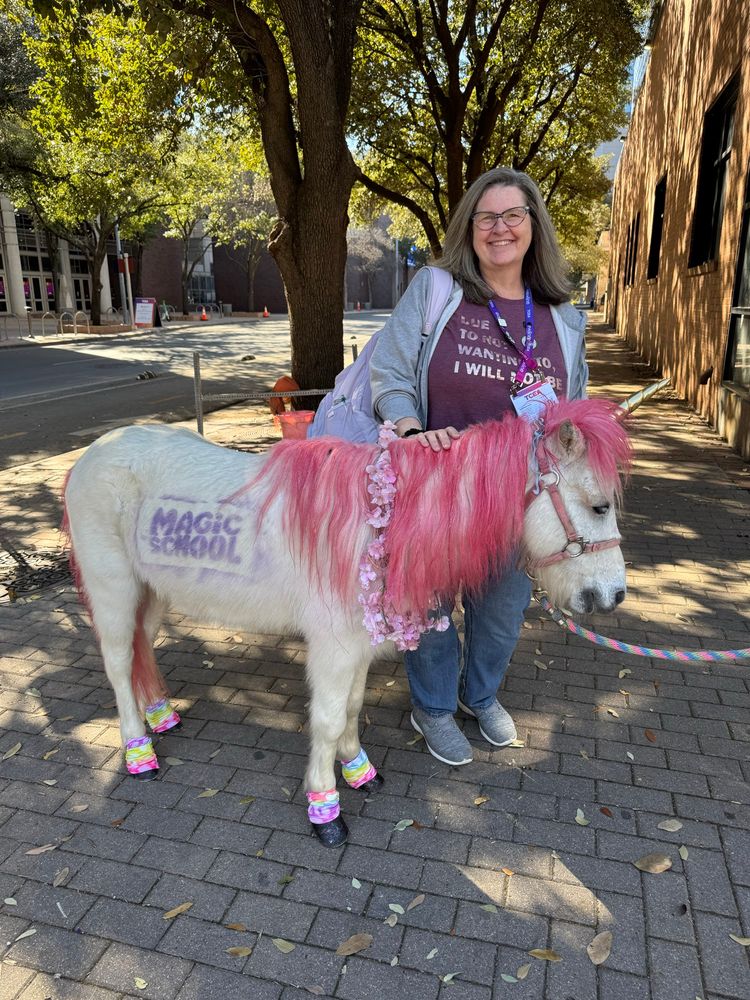 Woman with a pony dressed as a unicorn.