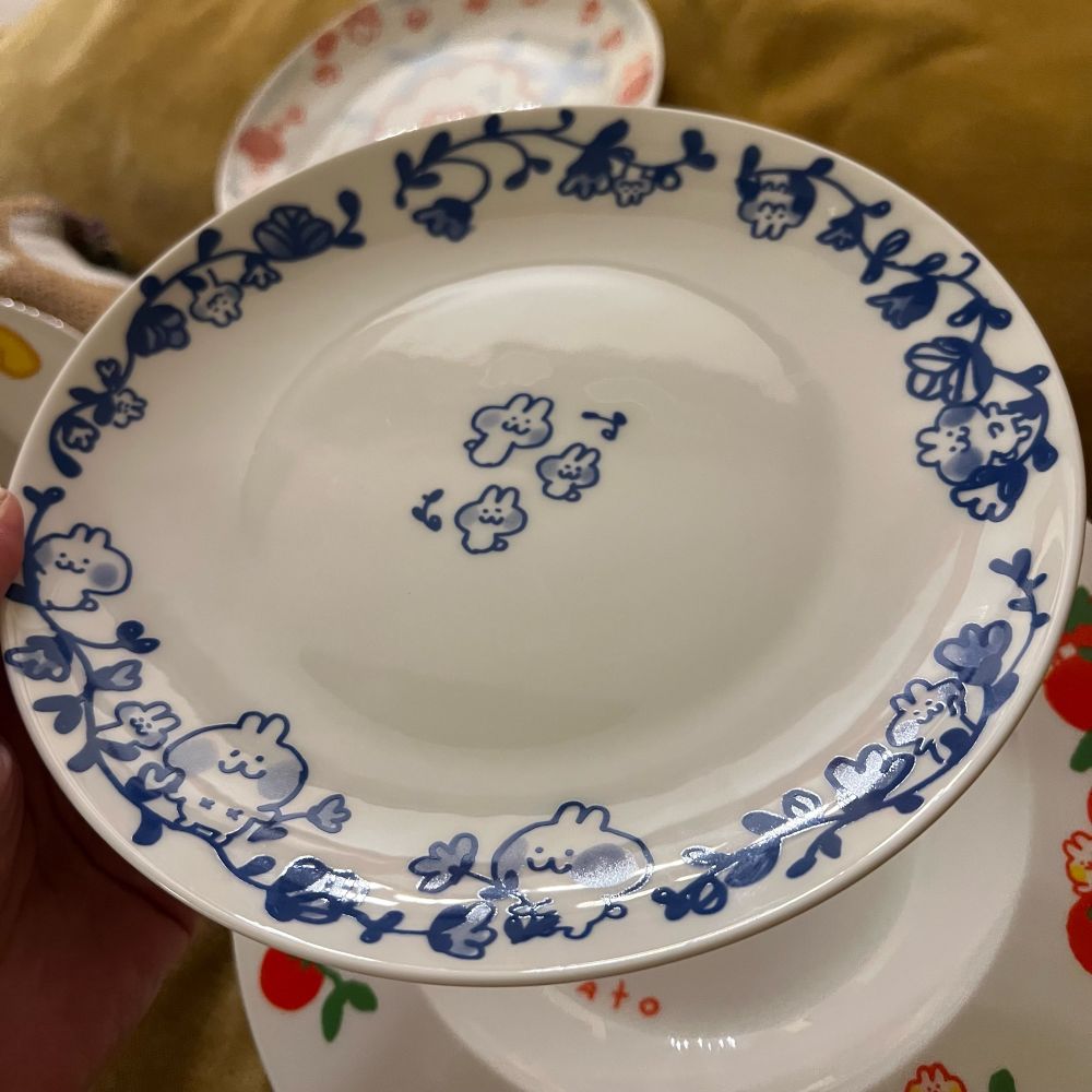 a dessert plate with porcelain blue drawings of florals and bunnies