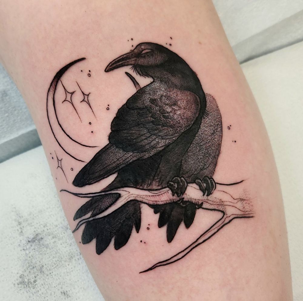 Blackwork tattoo of a raven perched on a branch, with a moon behind it