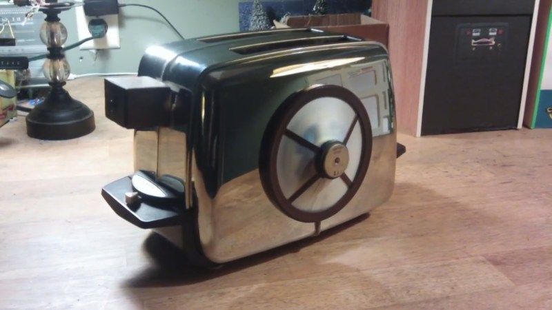 A retro future style toaster in silver and brown. Star of the Red Dwarf TV show as Talkie Toaster. Always asking if people want toasted bread products.