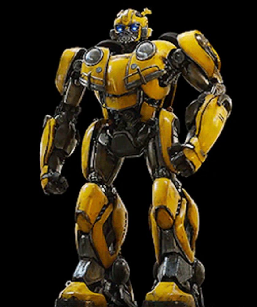 a yellow robot with blue eyes is standing on a black surface .