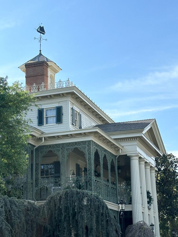 Haunted Mansion at Disneyland Resort at Anaheim in Southern California! Where the crypt doors creek and the tombstones quake, there are nine hundred and ninety nine happy haunts all year round. Whether it’s the beginning of spring or the witching hour of Halloween, it’s always a festively frightfully good time here. Plenty of ghosts, ghouls, spectres, witches, and nightmares creeping around the mansion. Some say it’s actually haunted, but that’s just a legend.