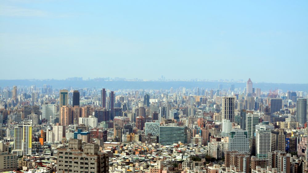 Photo of skyline of Taipei from 02/2025. Layers of buildings with a bit of green in the horizon.