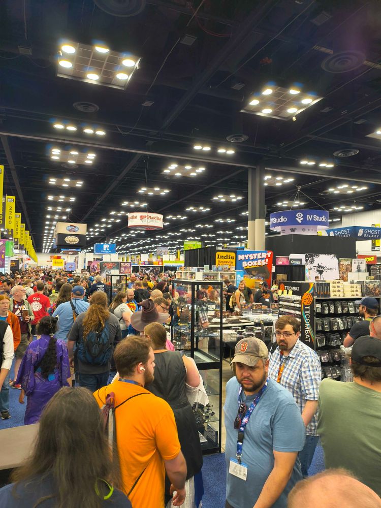 Gen Con floor. Several booths and people walking by