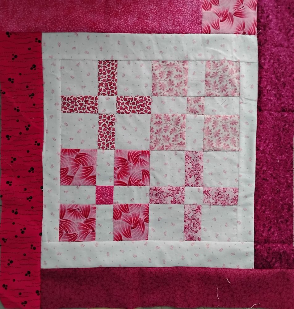 Quiltlet about 16" square made with leftover nine patch variant blocks set solid, alternating light and dark, with dark 2" borders