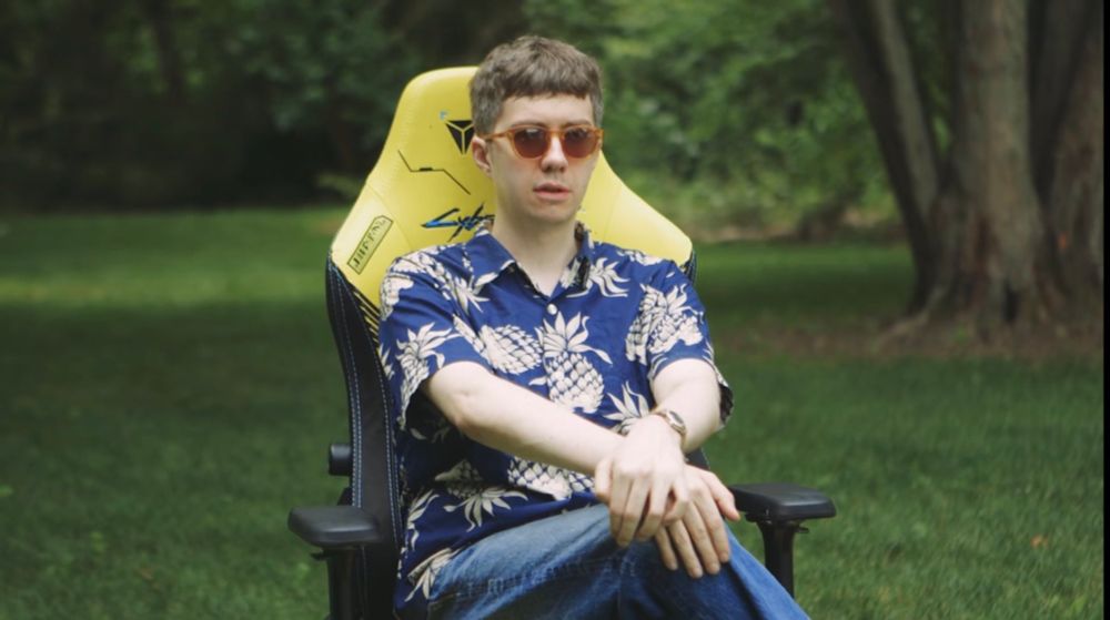 Tim Rogers sitting on a Cyberpunk 2077 gamer chair