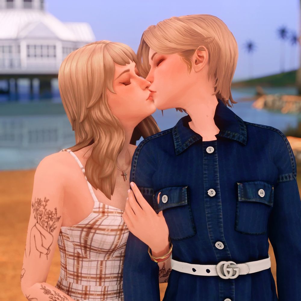 (cont.) Vic and Kate with their heads turned, sharing a kiss.

A tattoo of two girls embracing, with their heads replaced by flowers is visible on Kate's right bicep.